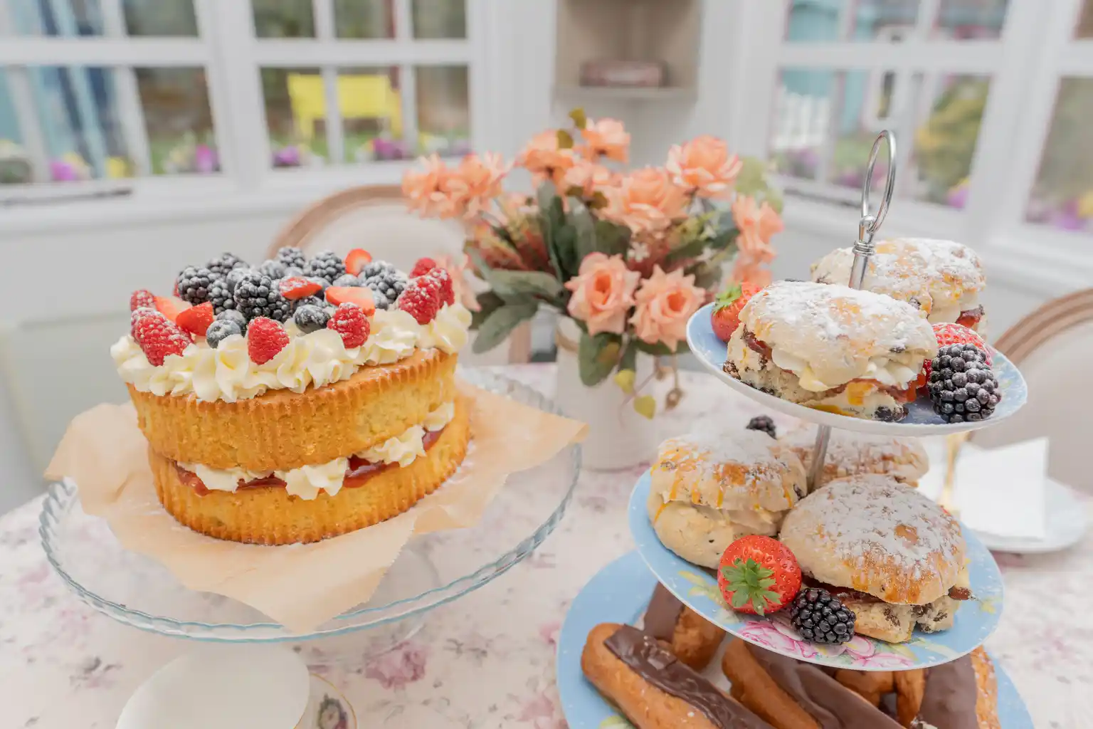 Afternoon tea with Victoria sponge, scones and fresh berries